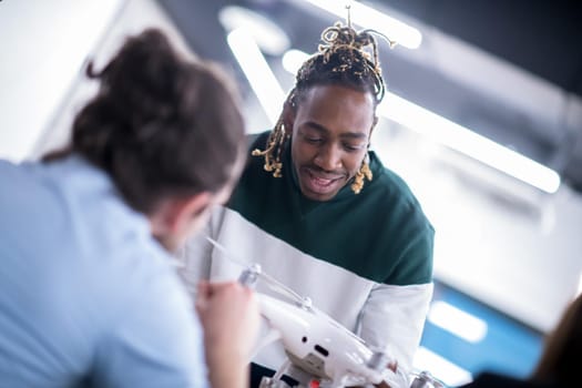 multiethnic startup business team discussing new business plan,working on laptop and tablet computer while learning about drone technology for new business advancement