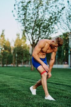 male athlete with pumped up body in parks crossfit workout. High quality photo