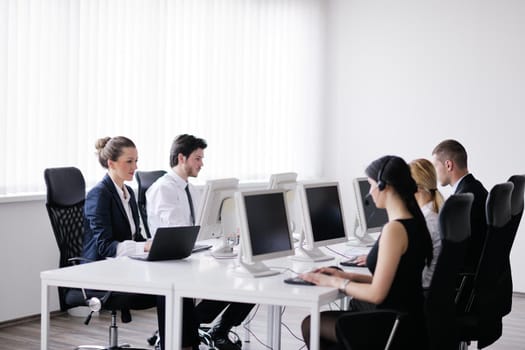 business people group with  headphones giving support in  help desk office to customers, manager giving training and education instructions