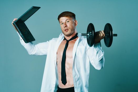 a man in a shirt with a pumped-up body laptop dumbbells business office. High quality photo