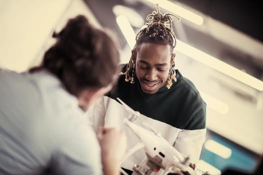 multiethnic startup business team discussing new business plan,working on laptop and tablet computer while learning about drone technology for new business advancement