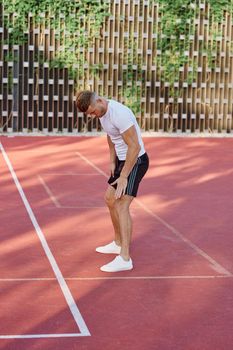 athletic men doing exercises on the sports ground in summer. High quality photo