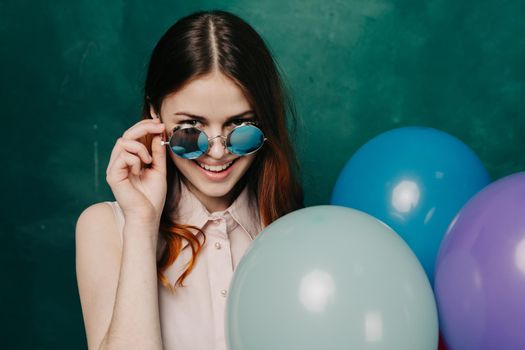 woman wearing fashionable glasses balloons holiday entertainment. High quality photo