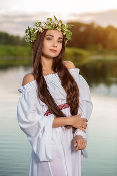 Woman in white dress in the water. Art Woman with wreath on her head in river. Wet witch Girl in the lake, mystical mysterious woman. Wreath on her head, Slavic traditions and paganism