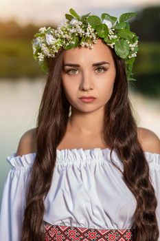 Woman in white dress in the water. Art Woman with wreath on her head in river. Wet witch Girl in the lake, mystical mysterious woman. Wreath on her head, Slavic traditions and paganism