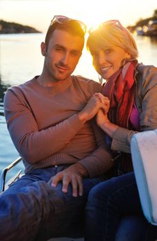 happy young couple in love  have romantic time at summer sunset   at ship boat while  representing urban and countryside fashin lifestyle