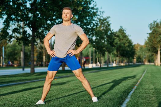 sporty man in the park on the lawn exercise lifestyle. High quality photo