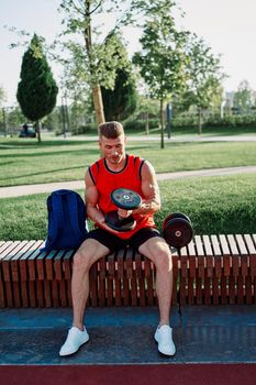 athletic man in red t-shirt in fitness park. High quality photo