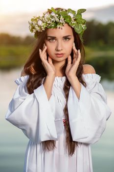 Woman in white dress in the water. Art Woman with wreath on her head in river. Wet witch Girl in the lake, mystical mysterious woman. Wreath on her head, Slavic traditions and paganism