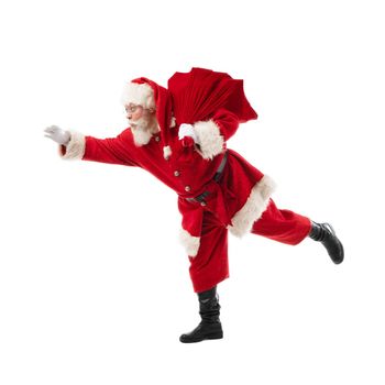 Happy running Christmas Santa with bag of gifts. Isolated over white background