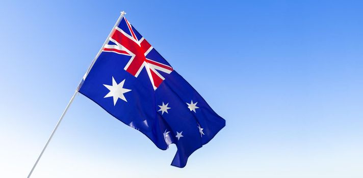 Flag of Australia waving against clear blue sky