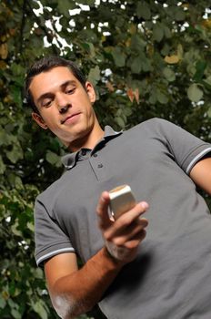 young happy  casual man talking on cellphone and writing sms message