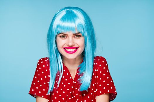 emotional woman in red dress blue wig red lips fashion. High quality photo