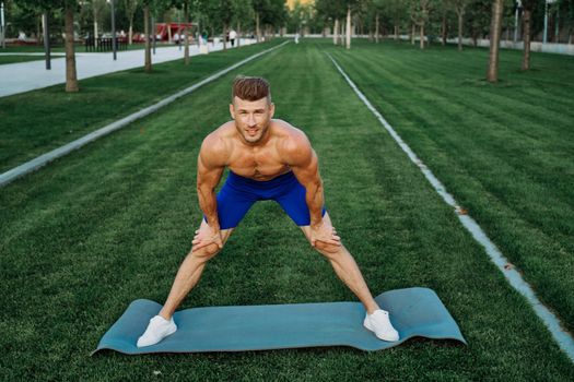 sporty man in shorts in the park working out outdoors. High quality photo