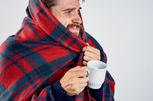 cold man with blanket warming drink health problem. High quality photo