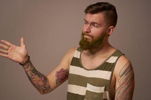 national bearded man in a striped jersey hipster tattoos on his arms. High quality photo