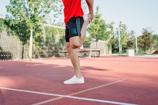 athletic man on sports ground workout exercise crossfit summer. High quality photo