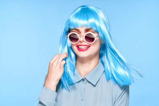 cheerful woman wearing sunglasses blue wig glamor model. High quality photo