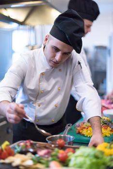 Chef finishing steak meat plate with Finally dish dressing and almost ready to serve at the table