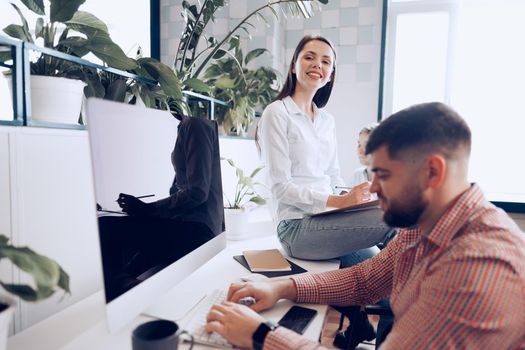 Young business people working together on project in modern office close up