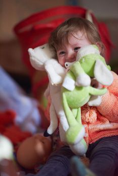 cute little child baby girl  playing with toys at home