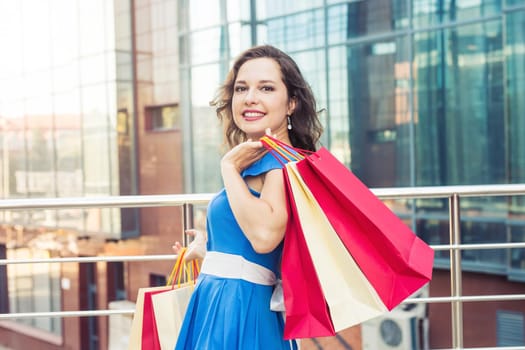 Happy woman with shopping bags enjoying in shopping. Consumerism, shopping, lifestyle concept.