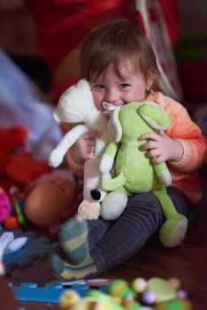 cute little child baby girl  playing with toys at home