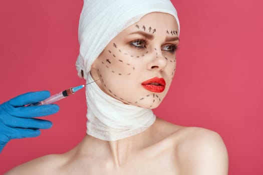 beautiful woman posing in blue gloves red lips surgery facial rejuvenation close-up. High quality photo