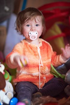 cute little child baby girl  playing with toys at home