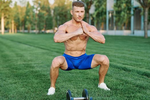 Muscled Man Doing Exercises Outdoor Fitness Summer. High quality photo