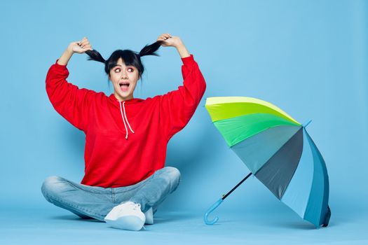 cheerful woman in red t-shirt rainbow color umbrella fashion. High quality photo