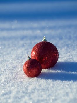 christmas balls tree decoration in fresh snow abstract background