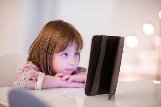 child playing with digital tablet at home