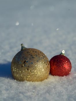 christmas balls tree decoration in fresh snow abstract background