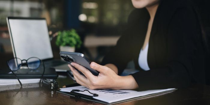 A businesswoman completes KYC using an online banking program in order to open a digital savings account. The definition of cyber security