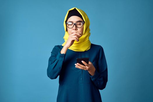 woman in yellow hijab technology calculator work finance. High quality photo