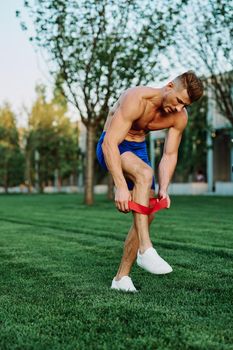 male athlete with pumped up body in parks crossfit workout. High quality photo