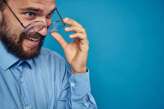 business man with glasses emotions blue background. High quality photo