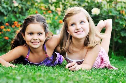 two happy young girls children  have fun outdoor in nature