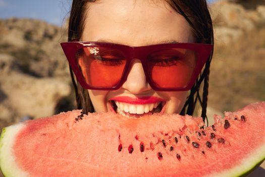 Cheerful woman eating watermelon nature summer vacation. High quality photo