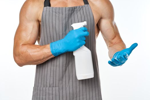 sporty muscular man wearing an apron detergent cleaning. High quality photo