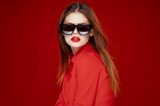 glamorous woman wearing sunglasses red shirt hairstyle model. High quality photo
