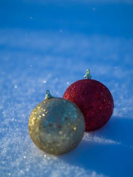 christmas balls tree decoration in fresh snow abstract background