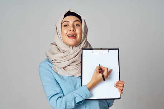 Muslim woman in hijab documents office work. High quality photo