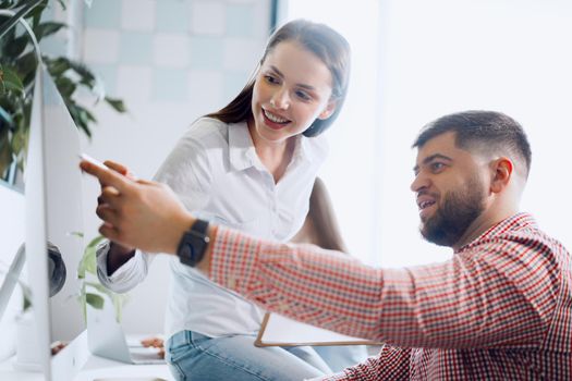Young business people working together on project in modern office close up
