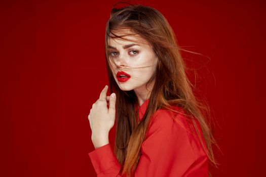 woman with red hair fashion posing red shirt glamor. High quality photo