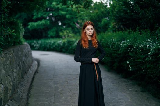 woman in black dress nature walk garden trees fresh air. High quality photo