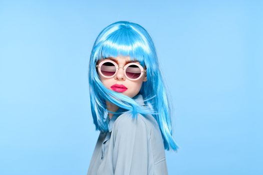 cheerful woman wearing sunglasses blue wig glamor model. High quality photo