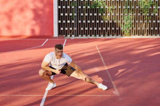 man on the sports ground exercise warm-up lifestyle. High quality photo