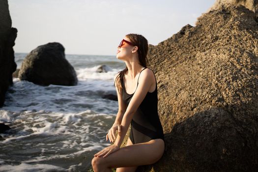 pretty woman in swimsuit island rocks posing summer. High quality photo